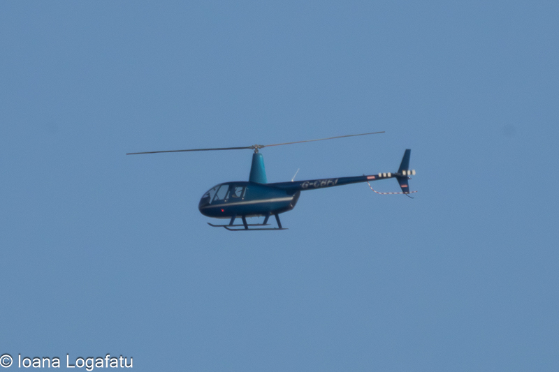 Helicopter soaring through the clear blue sky